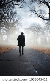 A Man In A Black Coat In Foggy Weather