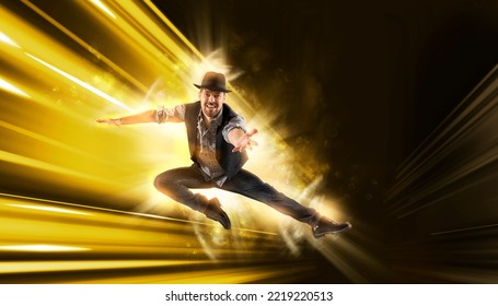 Man With Black Hat Dancing On Yellow Neon Background. Contemporary Ballet