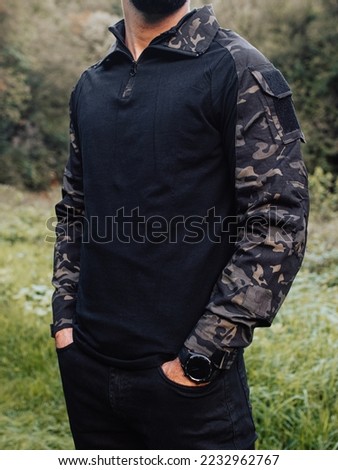 Man in black military suit.Tactical gear.Model fashion