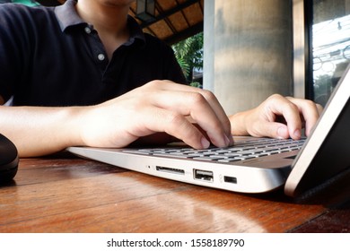 Man With Black Polo Shirt Working On His Laptop At Home During Covid-19 Disease.