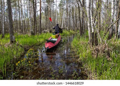 Man In Black Pulls Canoe On The River