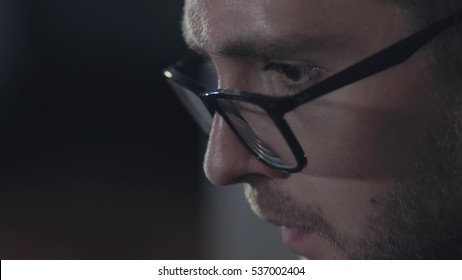 Man In Black Rim Glasses Using His Computer In Office. Businessman With Screen Reflection In The Lens