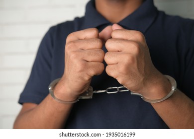 man in black shirt with handcuff 