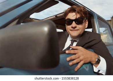 Man In Black Suit Driving His Lovely Retro Car