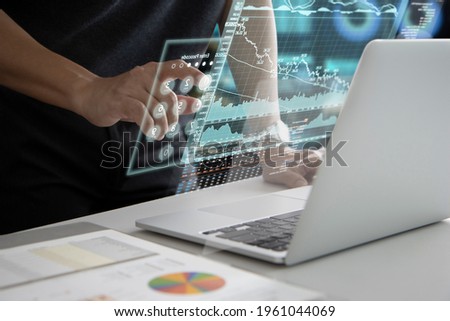 Man in black touching on futuristic virtual touch screen or augmented reality numeric keypad while entering security passcode to login to investment information analysis