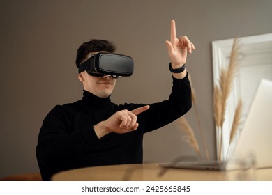 Man in black turtleneck using virtual reality headset, experiencing cutting-edge technology in a home environment.