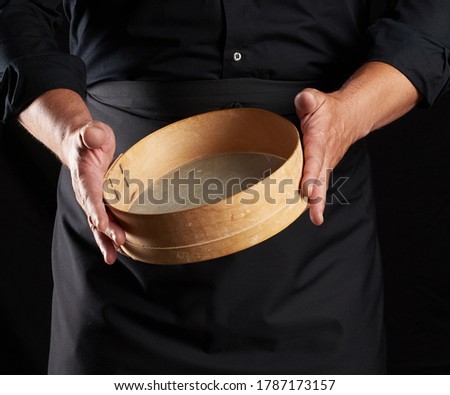 Similar – Image, Stock Photo man sifts white wheat flour through a wooden sieve