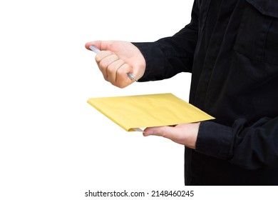 Man In Black Uniform Using A Retractable Ballpoint Pen To Sign A Yellow Shipping Envelope, Copy Space.