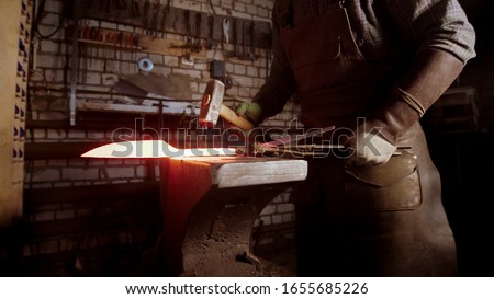 Similar – Image, Stock Photo Skilled blacksmith forging metal in traditional workshop