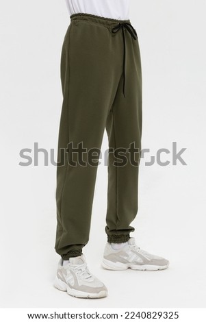 Man in blank green jogger pants mock-up