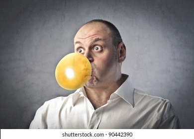 Man Blowing Bubbles With A Chewing Gum