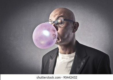 Man Blowing Bubbles With A Chewing Gum