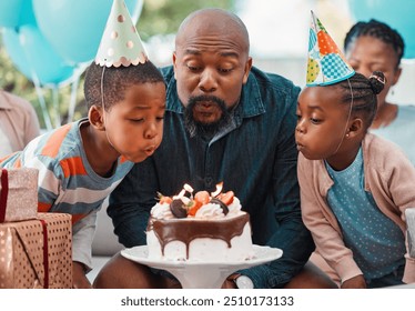 Man, blowing candles and birthday cake with children for celebration, gathering and event in home for happiness. African father, kids and excited at party with support, love and together for surprise - Powered by Shutterstock