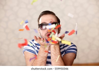 Man Blowing Confetti At Party