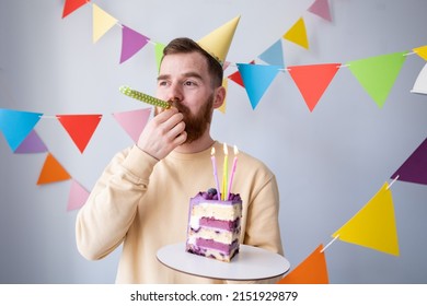 
Man Blowing Party Horn On Birthday