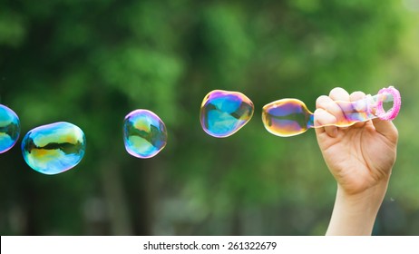 A Man Blowing Soap Bubbles