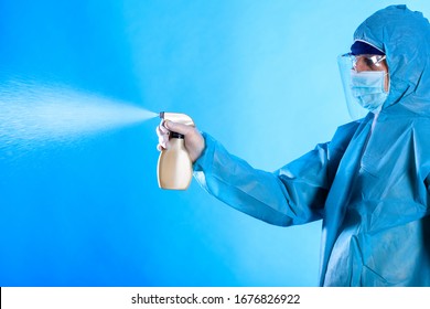 man in a blue full protected suit with disinfectant , conavirus pandemic - Cleaning and Disinfection. Infection prevention and control of epidemic