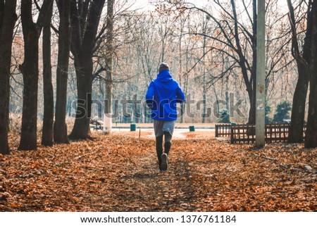 Similar – Young man running outdoors during workout in a forest