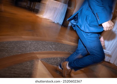 Man in blue pants with brown shoes Dancing on interesting pinwheel hard wooden floor - Powered by Shutterstock