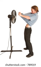 Man With Blue Shirt Cooling Down In Front Of A Fan.