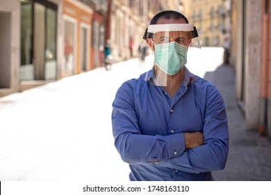 Man With Blue Shirt Face Mask And Plexiglass Screen In City Center