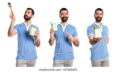 Man with blue shirt holding a paint pot