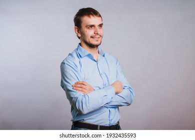 Man in a blue shirt on a white background office worker. A guy with a cute smile