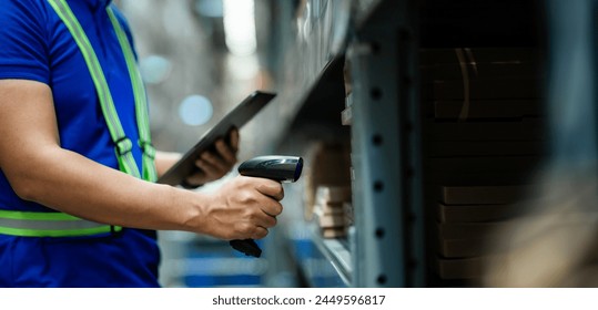 A man in a blue shirt is using a barcode scanner to scan a product. Concept of efficiency and productivity, as the man is using technology to quickly and accurately identify the product - Powered by Shutterstock