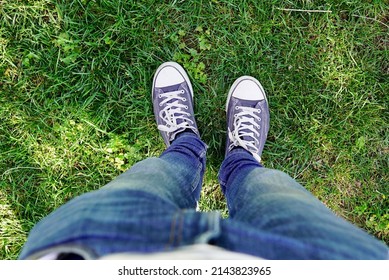 Man with blue sneakers and green grass on it. Farmhouse Park (Two Sisters). Andalusia, Spain. Two sisters.
