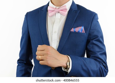 Man In Blue Suit With Pink Bow Tie, Flower Brooch, And Pink Blue Strip Pocket Square, Close Up