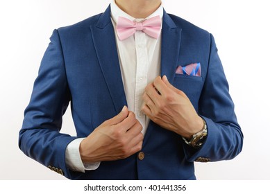 Man In Blue Suit With Pink Bow Tie, Flower Brooch, And Pink Blue Stripe Pocket Square, Close Up