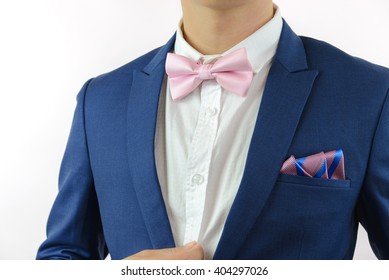 Man In Blue Suit With Pink Bow Tie, Flower Brooch, And Pink Blue Strip Pocket Square, Close Up