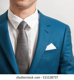 Man In Blue Suit With Silver Necktie, White Shirt And Pocket Square, Close Up