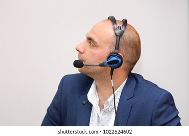 Man In Blue Suit With Voice Technology Headset