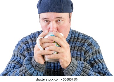 Man in blue sweater sweater drinking hot beverage looking upwards on white