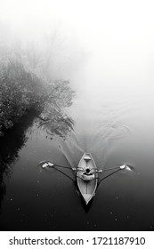 Man In Boat In Fog. Misty River. Black White Photo. Autumn Landscape