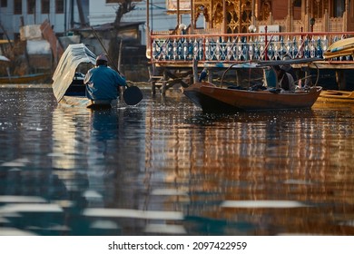 Man in the boat is sailing to home. February Dal lake Srinagar Kashmir