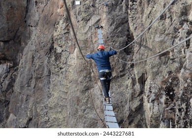 Man in body harnesses feature life-safety, viaferrata in mountains of pyrenees