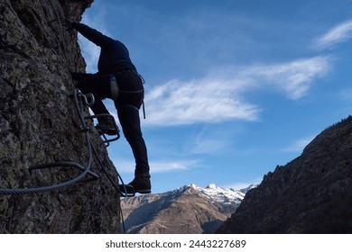 Man in body harnesses feature life-safety, viaferrata in mountains of pyrenees