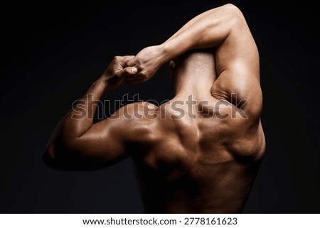 Man, bodybuilder and back in studio with triceps, muscle growth and healthy body on black background. Person, wellness and shoulders for flex with power, strong arms or change for transformation