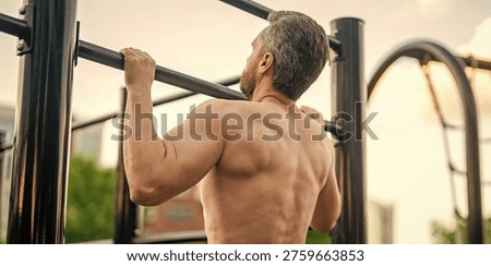 Man bodybuilder do pullup exercise. Muscular biceps and triceps. Strong athlete. Man pullup at outdoor gym. Muscular man with strong back muscle. Gym bar. Sport pullup workout. Sport training