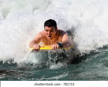 Man Boogie Boarding At The Beach