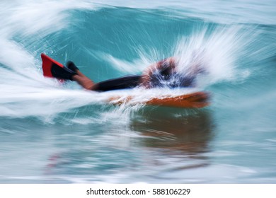 A Man Boogie Boarding In Tropical Water