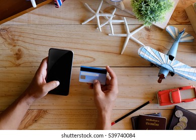 Man Booking Tickets Online By Smartphone And Credit Card. Or Do Online Checkin.