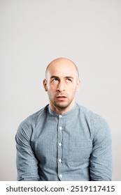 Man, bored and annoyed face in studio for rude personality, negative reaction and goofy with rolled eyes. Male person, thinking and disappointed facial expression on white background for frustrated