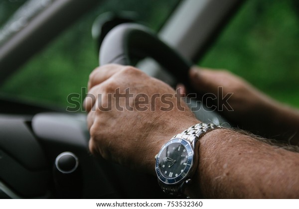 A man with both hands safely on the
steering wheel, right hand drive united
kingdom