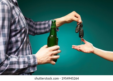  A Man With Bottle Beer Giving A Car Key To Someone For Driving The Car.Do Not Drink And Drive! Drunk Driving. Drink And Auto Keys.