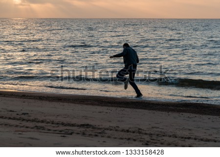 Similar – Image, Stock Photo Young woman with pipe backlit by the sea in the midnight sun