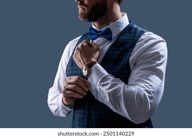 Man in bowtie and watch. Elegant watch accessory. Time. Elegant gentleman isolated on grey. Male accessory. Gentleman in bowtie show luxury watch. Expensive time wrist watch. Fashion Accessory - Powered by Shutterstock