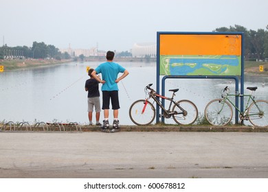 The man and the boy arrived by bicycle to the rowing channel. - Powered by Shutterstock